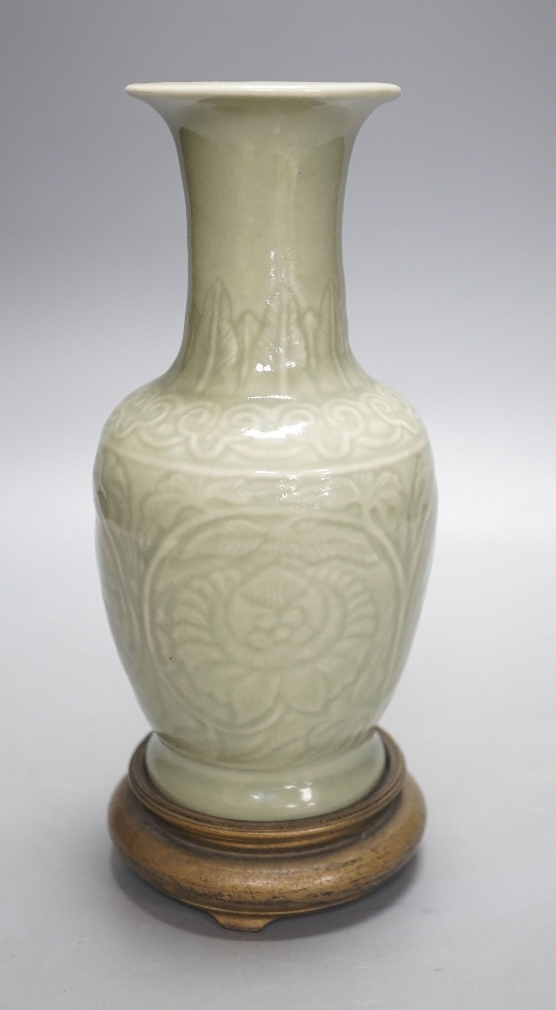 A Chinese celadon vase on stand, 24 cms high including stand.